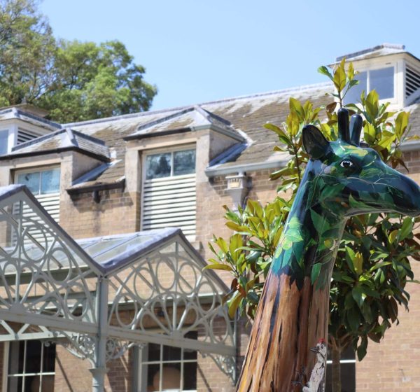 A painted sculptured giraffe in a courtyard at Holkham