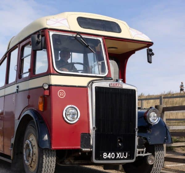 A red and cream vintage bus