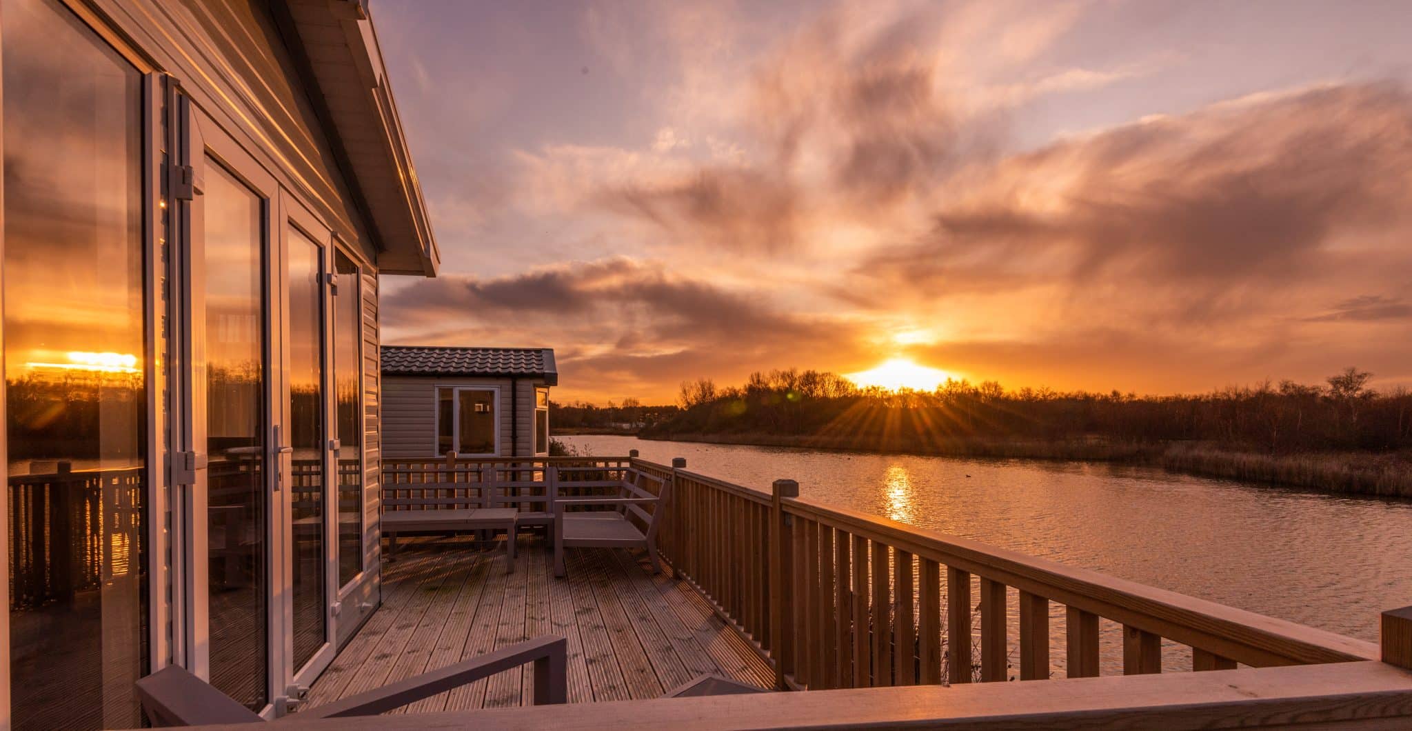 A beautiful sunset from the decking of a Pinewoods caravan holiday home