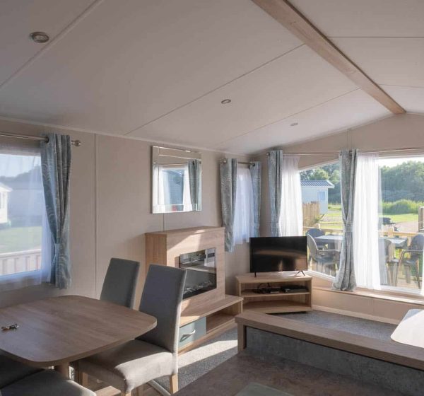 The sunny interior of a beach caravan at Pinewoods Holiday Park.